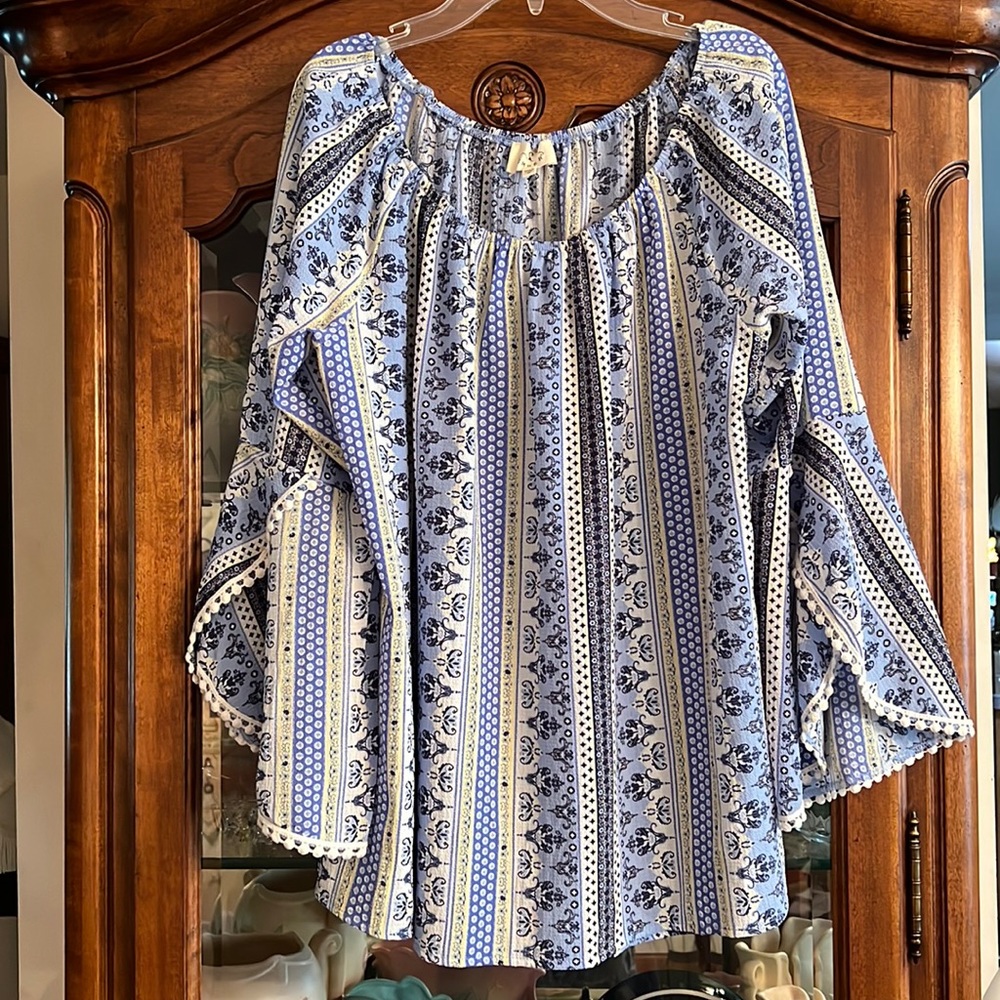 Ember Boho top with unique trim and bell sleeves.